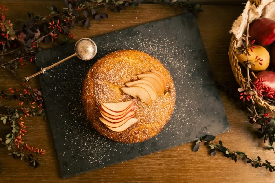 A table topped with a donut covered in icing