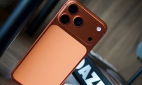Close-up of a copper-colored smartphone with three cameras.