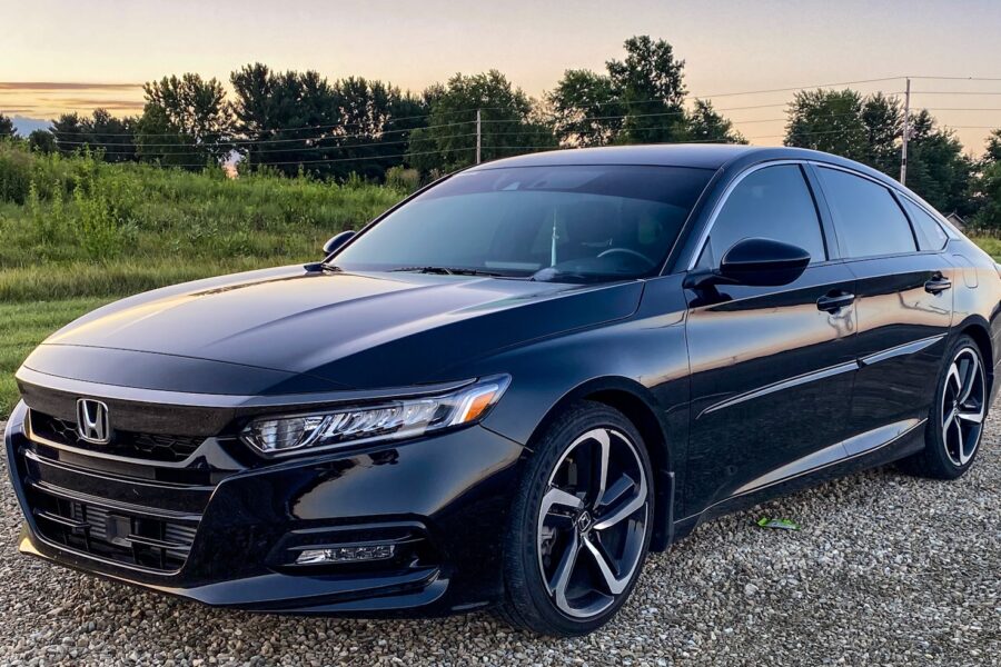 a black car parked on a gravel road