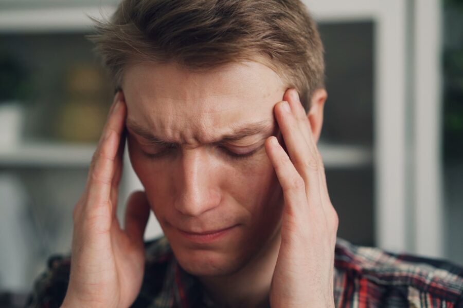 a man holding his hands to his ears