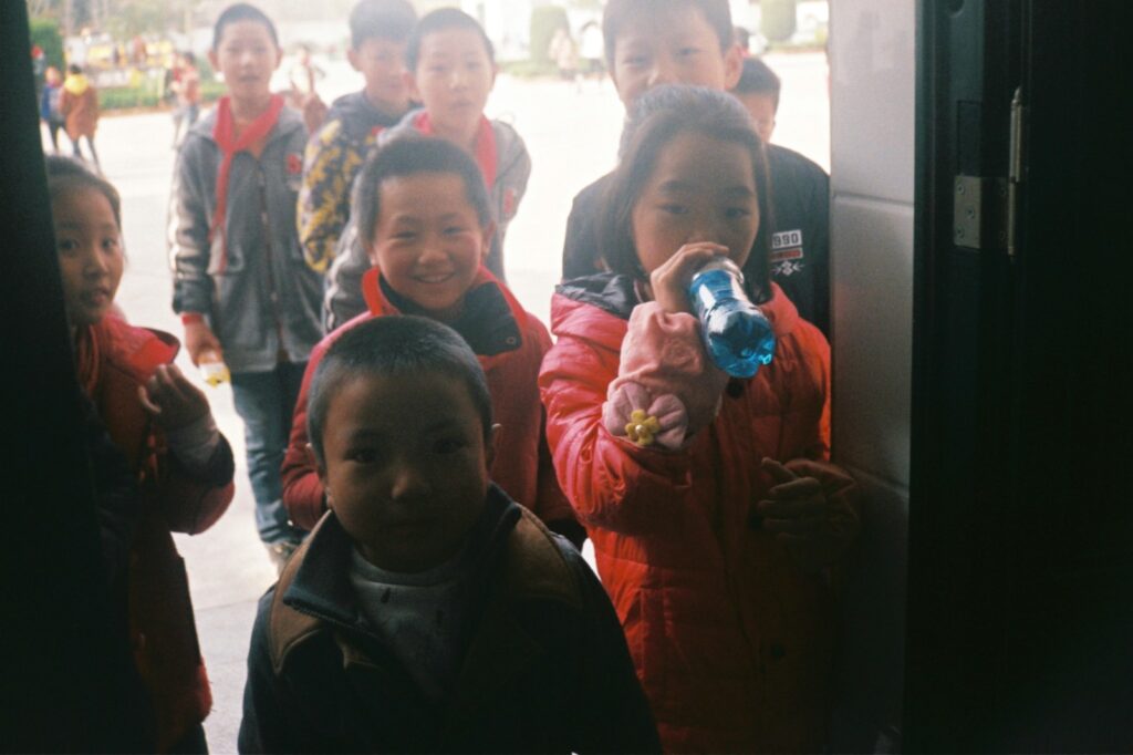 a group of young children standing next to each other