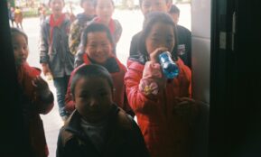 a group of young children standing next to each other