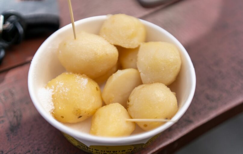 a white bowl filled with food on top of a wooden table