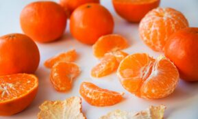 sliced orange fruits on white ceramic plate