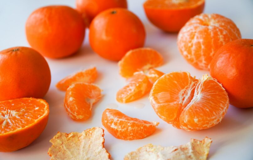 sliced orange fruits on white ceramic plate