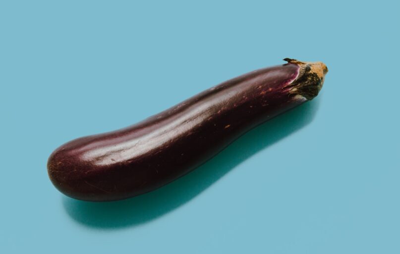 brown eggplant on teal surface
