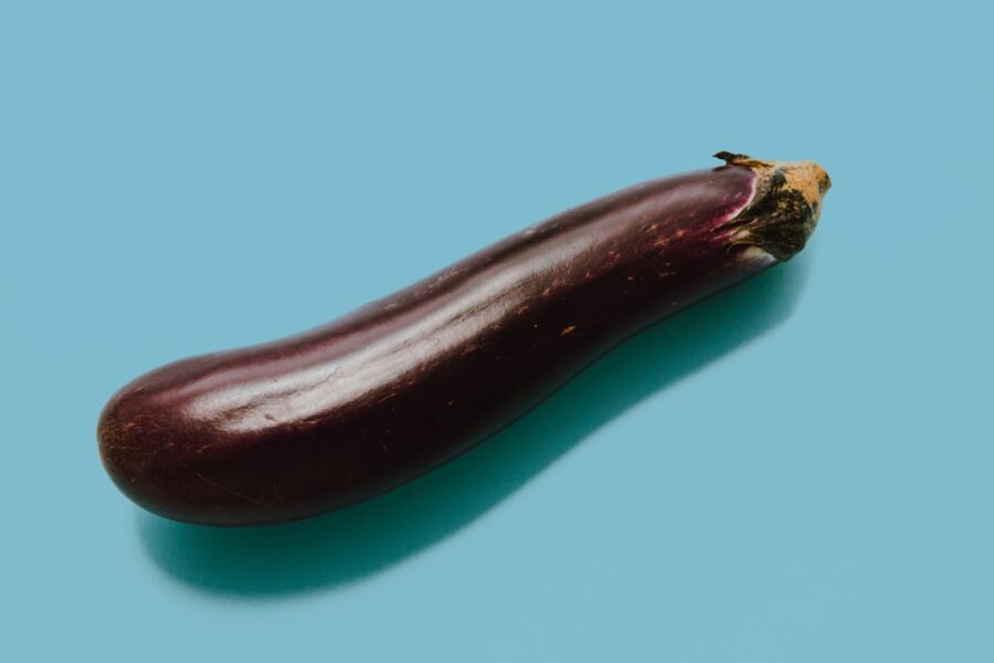 brown eggplant on teal surface