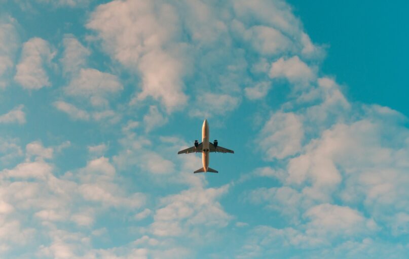 white airplane flying in the sky during daytime