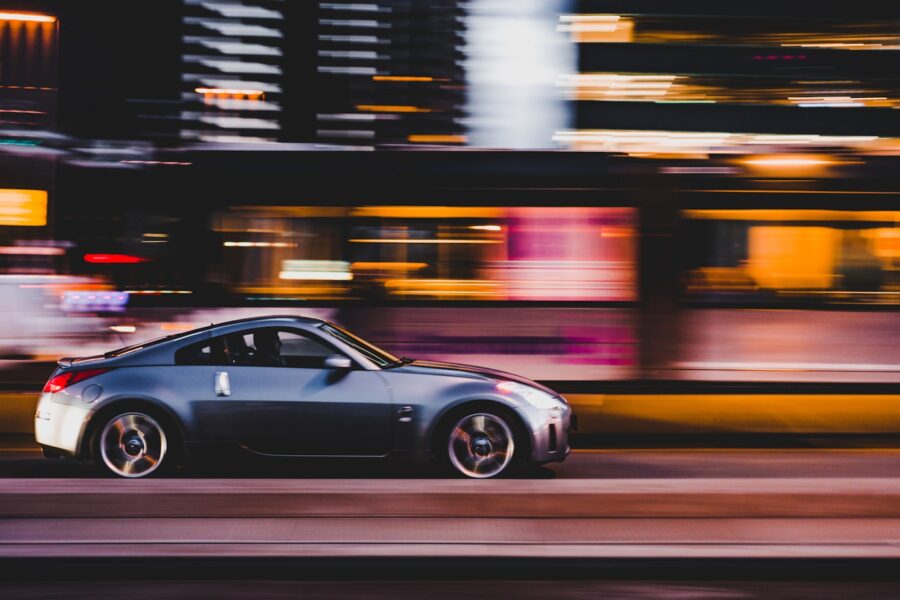 panning photography of gray coupe on road