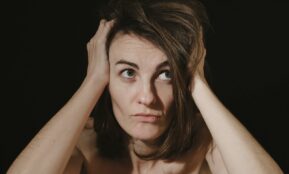 a woman holding her head in her hands