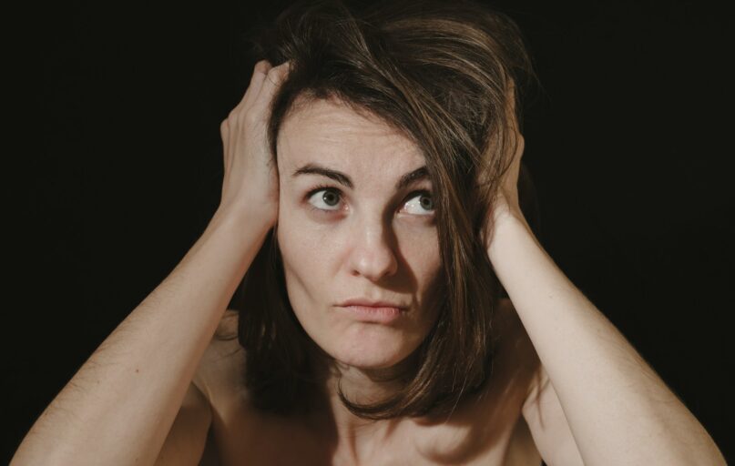 a woman holding her head in her hands