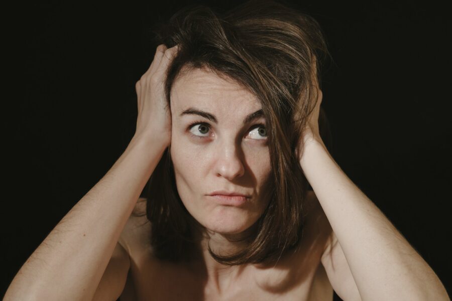 a woman holding her head in her hands