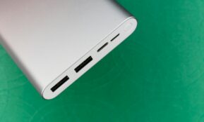 white electronic device on green textile