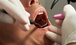 person with pink and black earbuds