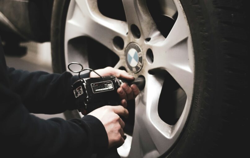 person in black jacket holding black smartphone