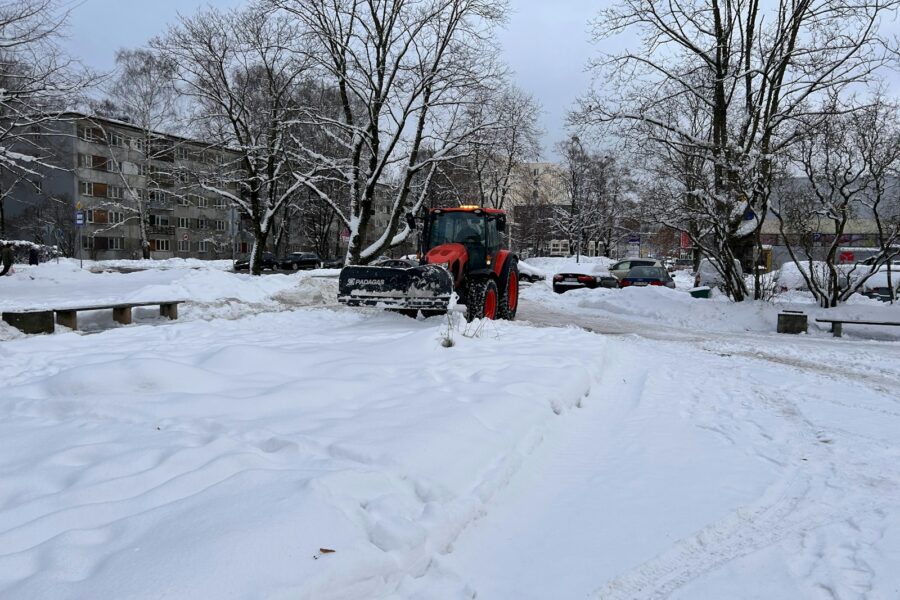 a snow plow is parked on a snowy street