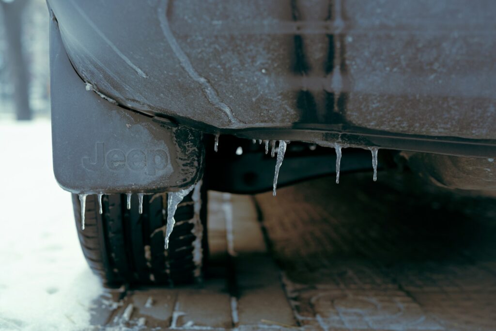 a close up of a car with icicles on it