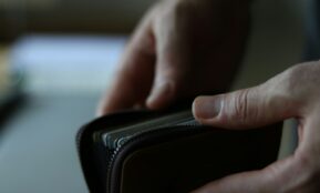 a person holding a wallet in their hand