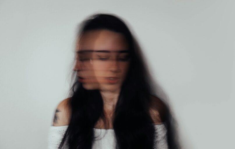 a blurry photo of a woman with glasses