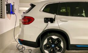 an electric car plugged in to a charging station