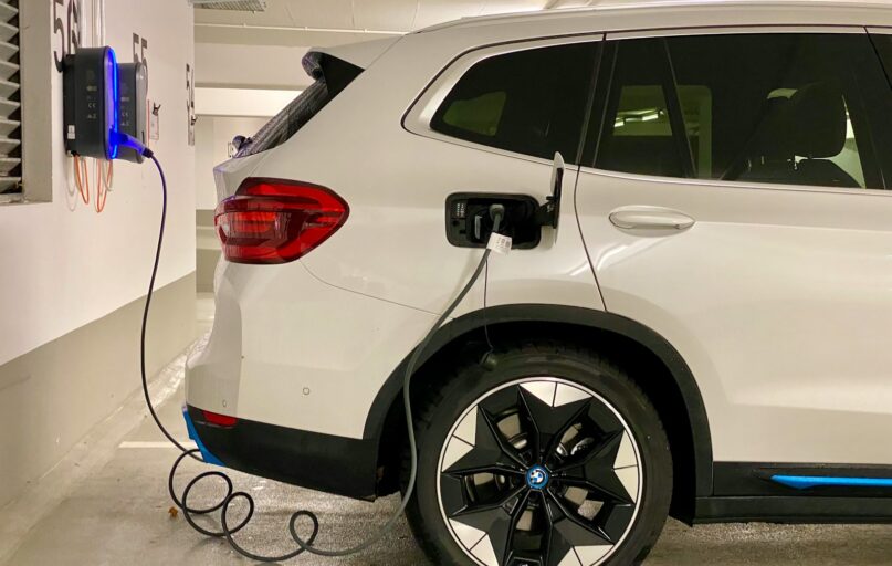 an electric car plugged in to a charging station