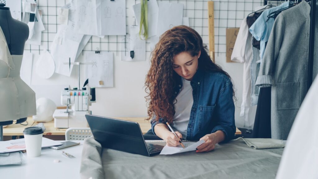 A fashion designer works at her desk.