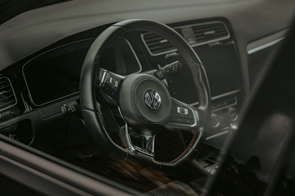 the interior of a car with a steering wheel and dashboard