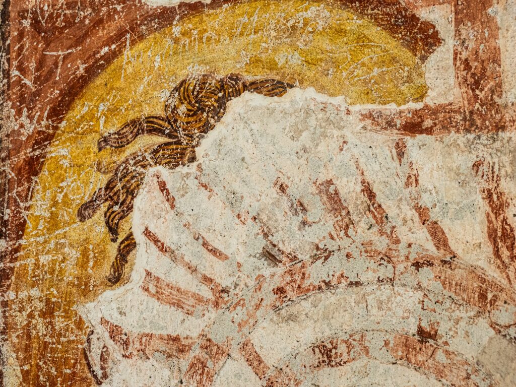 Ancient fresco depicting a figure with a halo.