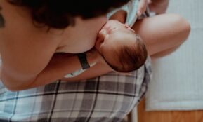 a woman holding a baby in her lap