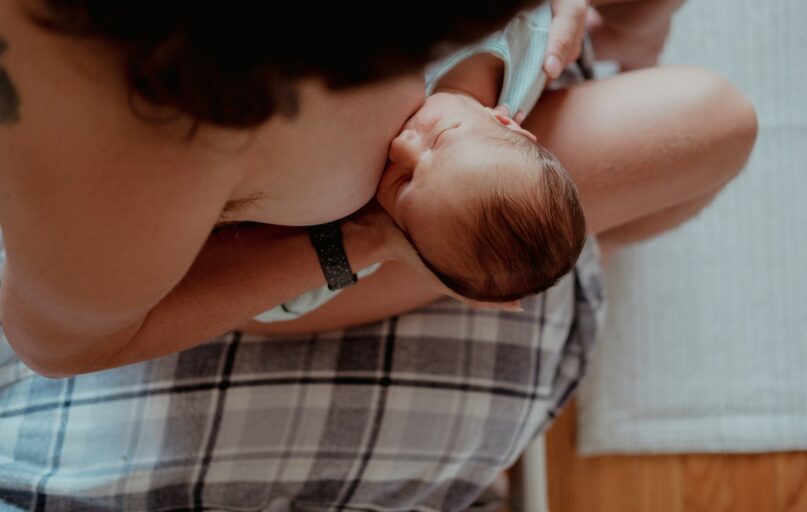 a woman holding a baby in her lap