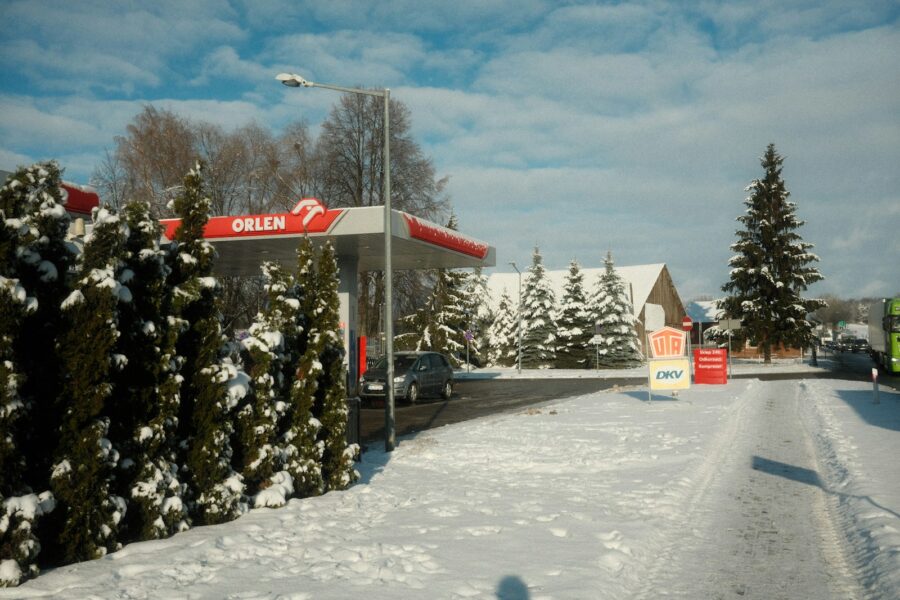 a gas station in the middle of a snowy street