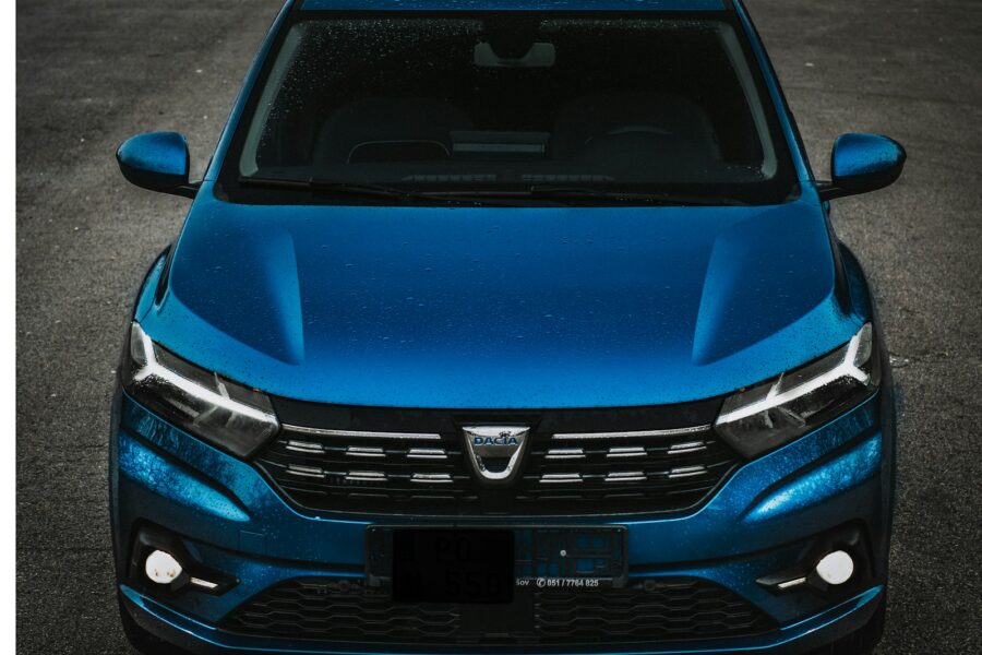 the front of a blue car parked in a parking lot