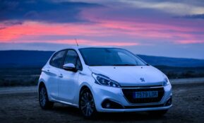 silver honda sedan on brown sand during sunset