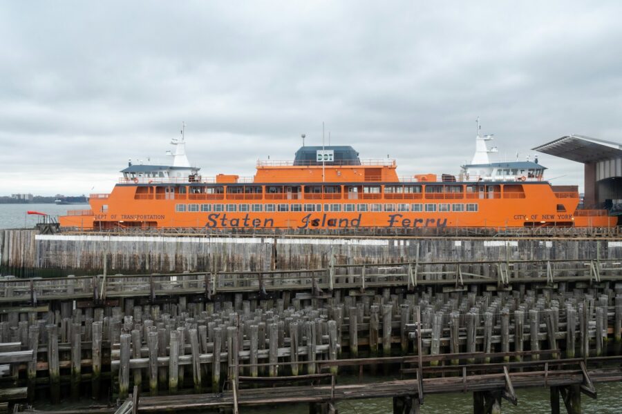 a large orange boat docked at a pier