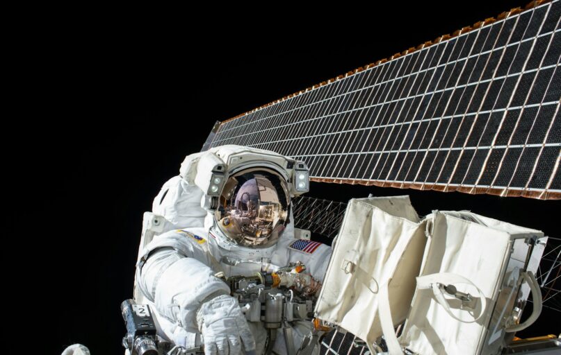 photography of Astronaut beside satellite