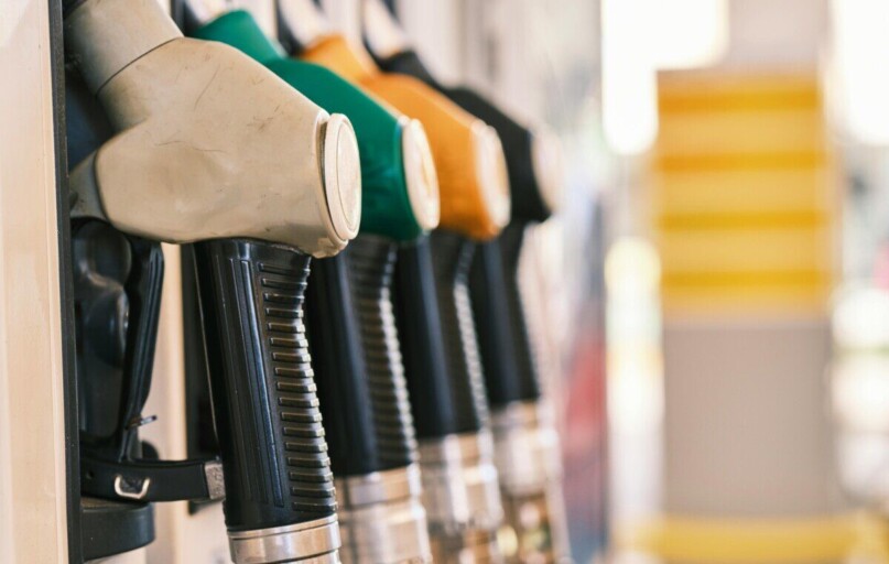 Close-up shot of colorful gas pump nozzles at a fuel station, emphasizing variety and choice.