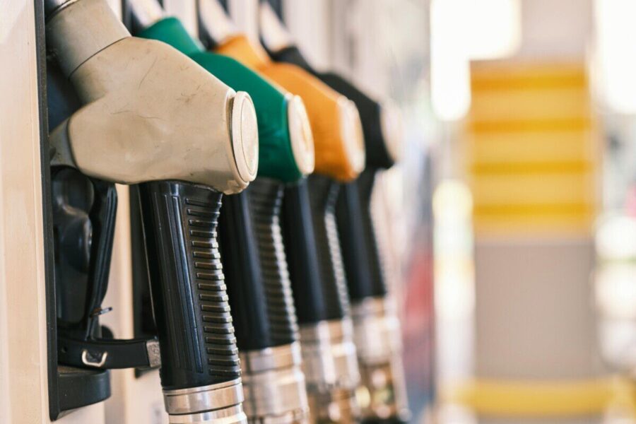 Close-up shot of colorful gas pump nozzles at a fuel station, emphasizing variety and choice.