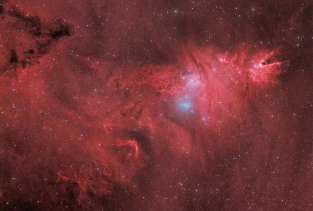 Explore the vivid colors of a red nebula against a star-filled cosmos.