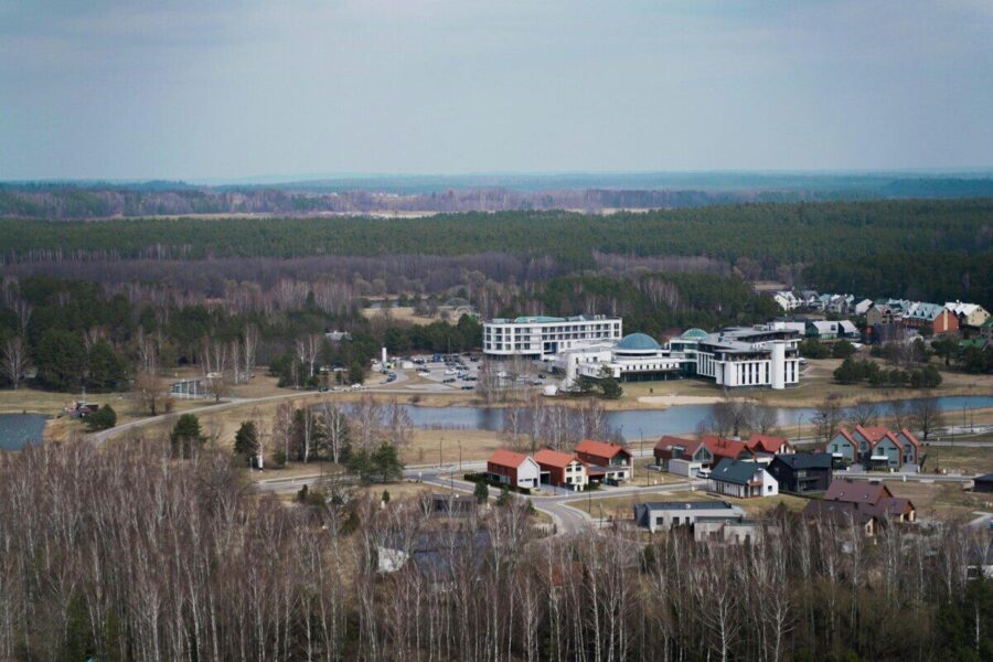 Explore Birštonas, Lithuania's mix of modern buildings and lush greenery from an aerial perspective.