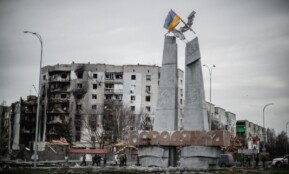 A monument stands beside war-torn buildings in Borodyanka, Ukraine.