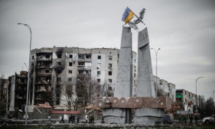 A monument stands beside war-torn buildings in Borodyanka, Ukraine.