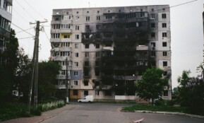 A heavily damaged apartment building in Borodyanka, Ukraine, illustrating urban devastation.