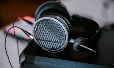 Close-up of professional headphones on a desk, featuring intricate design and modern audio technology.