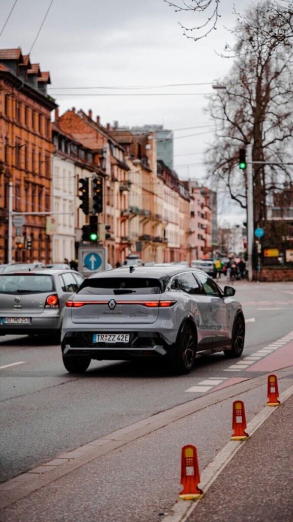 Modern electric vehicle driving through the streets of Heidelberg, Germany.