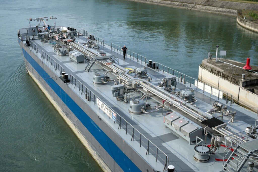 Aerial view of an industrial oil tanker docked at a harbor, showcasing modern maritime technology.