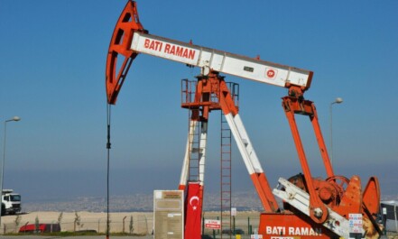 Bati Raman oil pump jack in Batman, Turkey. Industrial landscape with city view.