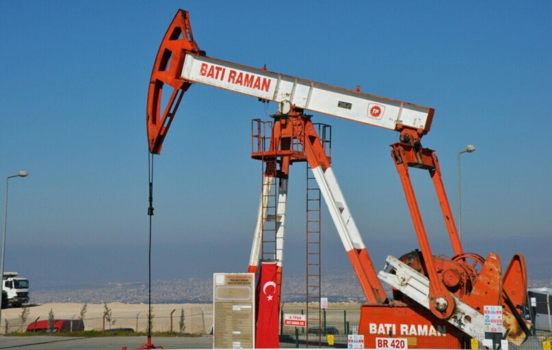 Bati Raman oil pump jack in Batman, Turkey. Industrial landscape with city view.