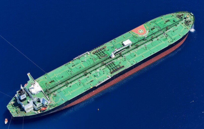 Aerial shot of an oil tanker sailing in the ocean near Vado Ligure, Italy.