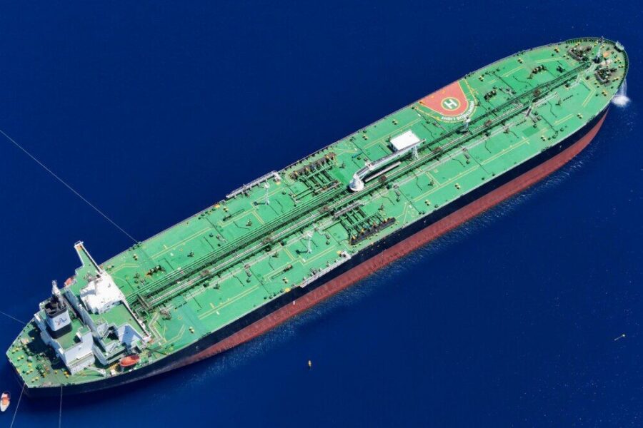 Aerial shot of an oil tanker sailing in the ocean near Vado Ligure, Italy.