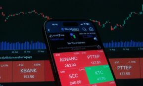 Mobile screen displaying stock market analysis with financial charts in the background.